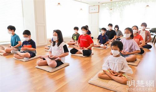 '图1～4：参加“法轮大法九天班”的孩子们正在学炼法轮功第五套功法。'