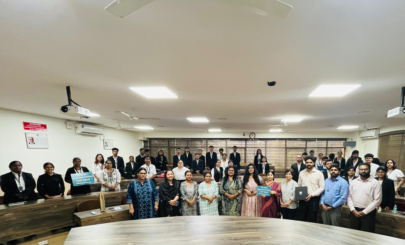 图1:前排从右至左依次为:DAFOH成员吉里达尔博士(Dr. Giridhar)、何塞·约翰尼(Jose Johny)和维平·穆德高德,法轮功学员奇特拉·德夫纳尼(Chitra Devnani),以及 IFIM 法学院副校长沙古芙塔·安朱姆博士(右起第五位)和她的教师团队